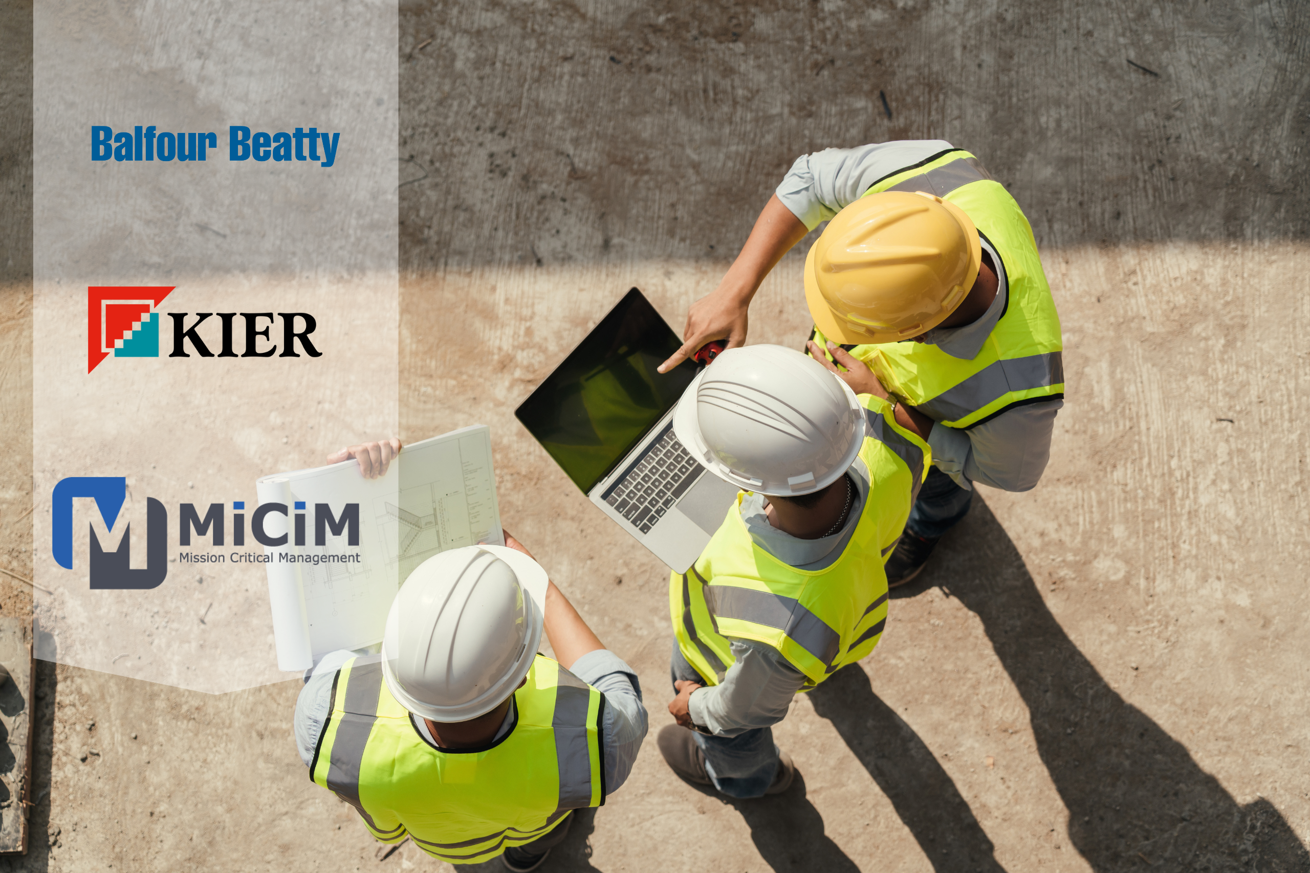 image of three construction workers around a laptop